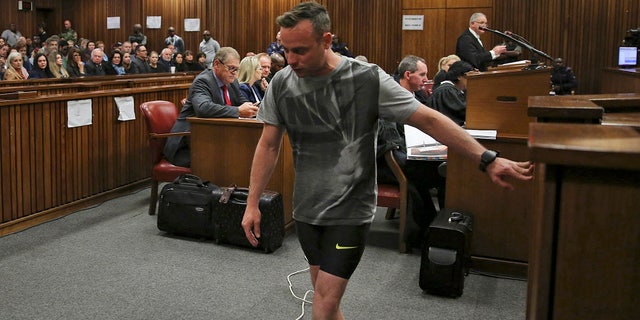 Oscar Pistorius, walks on his stumps during argument in mitigation of sentence by his defense attorney Barry Roux in the High Court in Pretoria, South Africa, Wednesday, June 15, 2016. An appeals court found Pistorius guilty of murder and not a lesser charge of culpable homicide for the shooting death of his girlfriend Reeva Steenkamp. (Siphiwe Sibeko, Pool Photo via AP)