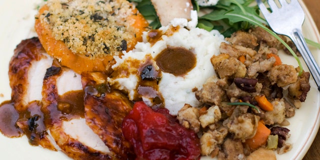 Oct. 8, 2012: A Thanksgiving dinner plate of cider brined turkey with sage gravy, peach cranberry sauce, sour cream and chive mashed potatoes, sausage pecan stuffing, arugula pear salad with pomegranate vinaigrette and goat cheese and herb crusted sweet potatoes.
