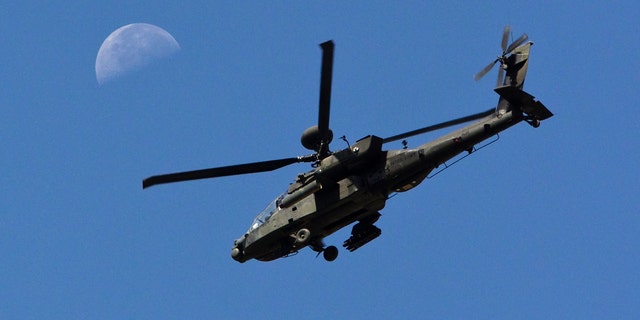 File photo - A U.S. Army Apache flies past the moon in the Zharay district of Kandahar province, southern Afghanistan June 11, 2012. (REUTERS/Shamil Zhumatov)
