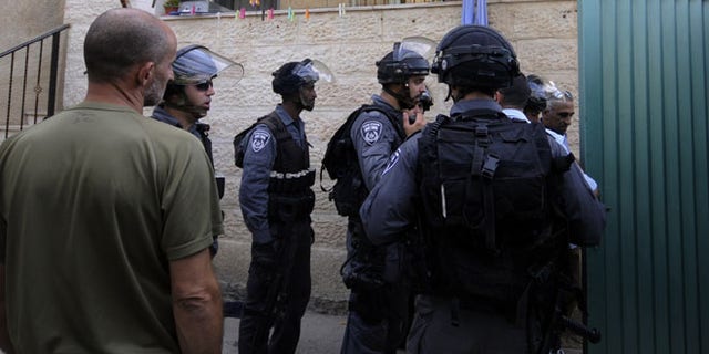 Sept. 30, 2014: Israeli police officers guard the house of Ziad Qarain, that Jewish settlers moved into, at the Palestinian neighborhood of Silwan, East Jerusalem