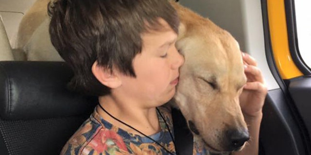 Canyon Mansfield, left, with his dog, Casey.