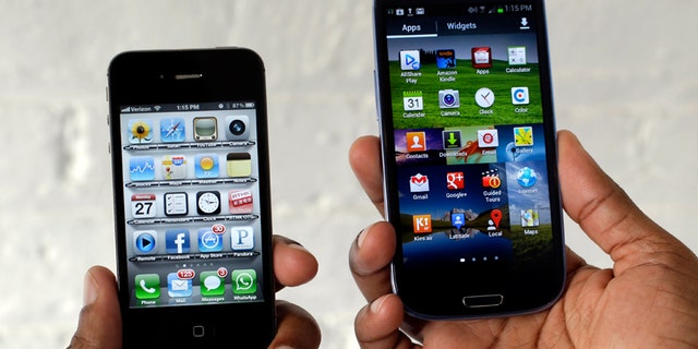 In this Aug. 27, 2012 photo, the Apple iPhone 4s, left, is displayed next to the Samsung Galaxy S III at a store in San Francisco.