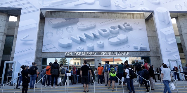 Attendees line up outside of the McEnery Convention Center for the Apple Worldwide Developers Conference in San Jose, Calif., Monday, June 4, 2018. (AP Photo/Marcio Jose Sanchez)