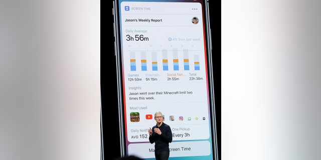 Apple CEO Tim Cook speaks in front of a Screen Time image during an announcement of new products at the Apple Worldwide Developers Conference Monday, June 4, 2018, in San Jose, Calif. (AP Photo/Marcio Jose Sanchez)
