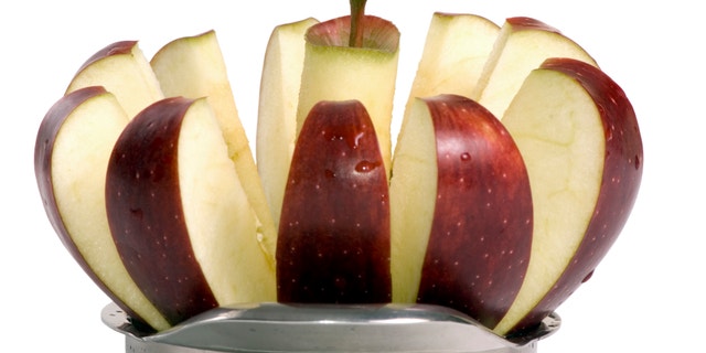 A sliced red apple isolated on white.