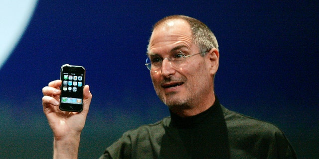 File photo - Steve Jobs holds the first iPhone in San Francisco, California January 9, 2007.
