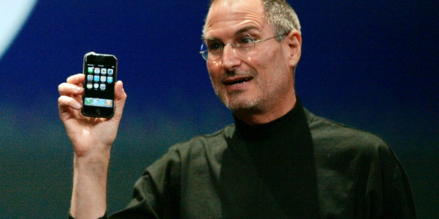 File photo - Steve Jobs holds the first iPhone in San Francisco, California January 9, 2007.