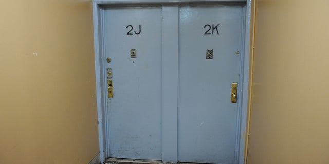 In the hallway outside the family's apartment, 2J.