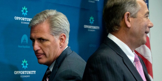 Sept. 29, 2015: House Majority Leader Kevin McCarthy of Calif., left, squeezes behind outgoing House Speaker John Boehner of Ohio at the start of a news conference on Capitol Hill in Washington.