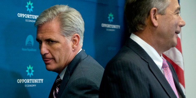 Sept. 29, 2015: House Majority Leader Kevin McCarthy of Calif., left, squeezes behind outgoing House Speaker John Boehner of Ohio at the start of a news conference on Capitol Hill in Washington.