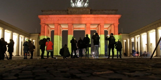 The Brandenburg Gate is illuminated in the colors of the German flag in Berlin, Germany, Tuesday, Dec. 20, 2016, the day after a truck ran into a crowded Christmas market and killed several people. (AP Photo/Markus Schreiber)