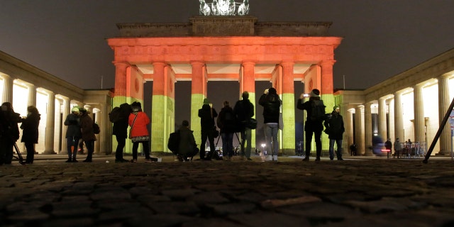 The Brandenburg Gate is illuminated in the colors of the German flag in Berlin, Germany, Tuesday, Dec. 20, 2016, the day after a truck ran into a crowded Christmas market and killed several people. (AP Photo/Markus Schreiber)