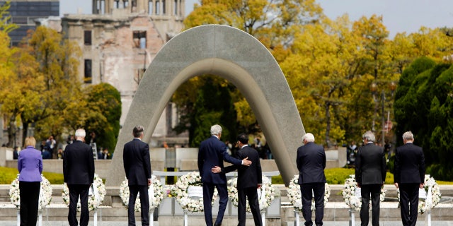 April 11, 2016: U.S. Secretary of State John Kerry, center left, puts his arm around Japan's Foreign Minister Fumio Kishida, center right, after they and fellow G7 foreign ministers laid wreaths at the cenotaph at Hiroshima Peace Memorial Park in Hiroshima, Japan.