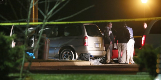 Police investigate the scene outside a Cracker Barrel restaurant in Kalamazoo where four people were shot and killed and another person was wounded.