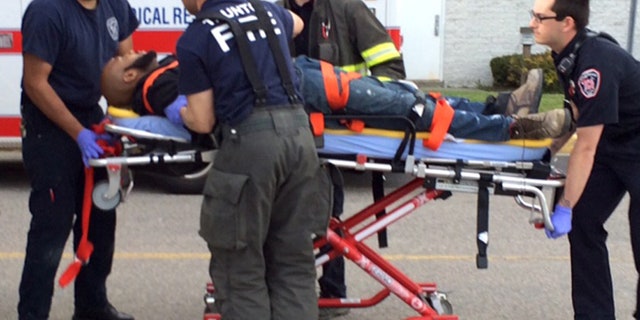 May 10, 2016: The suspect in the attacks at the Silver City Galleria mall in Taunton, Mass. is transported on a gurney into an ambulance by medical personnel.