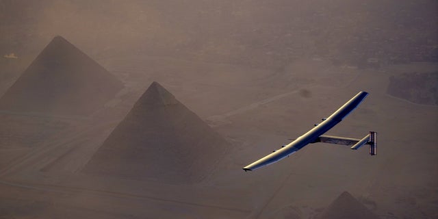 In this Wednesday, July 13, 2016, handout image provided by Solar Impulse, the Solar Impulse 2 flying over the pyramids, Egypt Cairo. The experimental solar-powered airplane has arrived in Egypt as part of its global voyage.