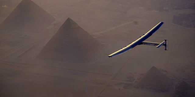 In this Wednesday, July 13, 2016, handout image provided by Solar Impulse, the Solar Impulse 2 flying over the pyramids, Egypt Cairo. The experimental solar-powered airplane has arrived in Egypt as part of its global voyage.