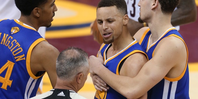 June 16, 2016: Golden State Warriors guard Stephen Curry is held back from referee Jason Phillips by Shaun Livingston, left, and Klay Thompson, right, while reacting to being called for his sixth foul during Game 6 of the NBA Finals