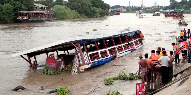 Thai rescue teams search for victims after a boat capsized in Thailand on Sunday.
