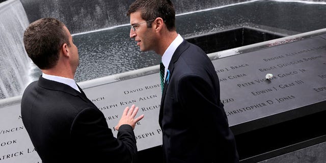 Architect Michael Arad (R), who designed the 9/11 Memorial, visits the North Pool of the 9/11 Memorial during ceremonies marking the 10th anniversary of the 9/11 attacks on the World Trade Center, in New York, September 11, 2011. (REUTERS/Justin Lane)