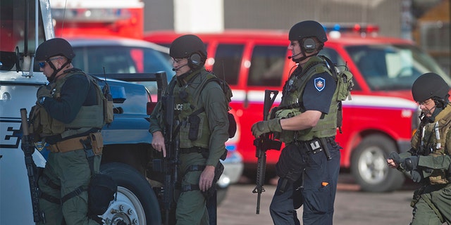 Dec. 13, 2013: Armed law enforcement officers gather at Arapahoe High School, after a student opened fire in the school in Centennial, Colorado.