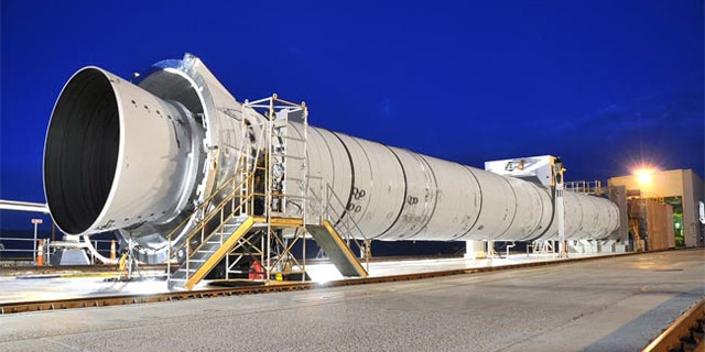 NASA's next-generation, five-segment solid rocket development motor -- or DM-2 -- is fully assembled in its test stand at ATK in Promontory, Utah. Tuesday morning, engineers plan to conduct a static-fire test -- firing the rocket horizontally while it's bolted to the ground.