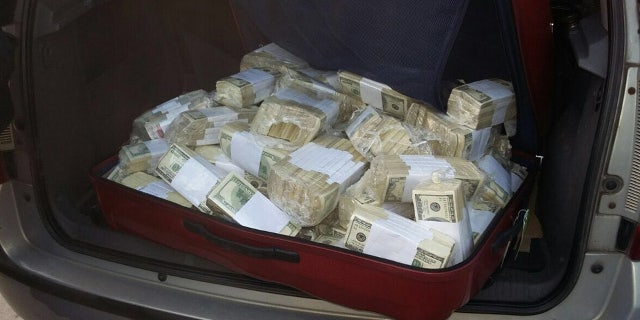 June 14, 2016: In this photo released by the Buenos Aires Province Security Ministry, wads of cash sit in the back of a vehicle shortly after former Public Works Secretary Jose Lopez was caught by police hiding millions at a monastery in the outskirts of Buenos Aires