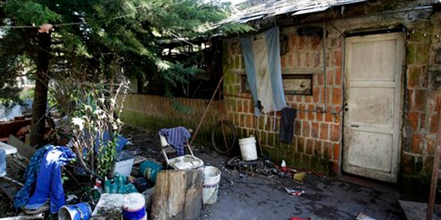 Sept. 5, 2015: An Argentine flag hangs from the home where Eduardo Oviedo is accused of keeping his wife and autistic son locked up in Mar del Plata, Argentina.