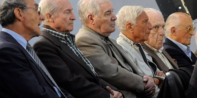 FILE - In this Nov. 2, 2009 file photo, former military, police and Argentina's last dictator attend the start of their trial in connection with human rights abuses during Argentina's dirty war in Buenos Aires. Argentina's last dictator and 14 other former military officials were sentenced to prison on Friday, May 27, 2016 for human rights crimes committed during the Operation Condor conspiracy to hunt down dissidents across the region. From left to right are former police officer German Montenegro, former army officers Jorge Osvaldo Garcia, Carlos Tepedino, Eugenio Guanabens, former and last dictator Gen. Reynaldo Bignone and former Gen. Omar Rivero. (AP Photo/Rolndo Andrade Stracuzzi, File)