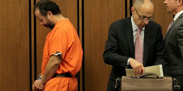Ariel Castro walks past his attorneys in Cuyahoga County Common Pleas Court, in Cleveland, Ohio, Wednesday, June 26, 2013.