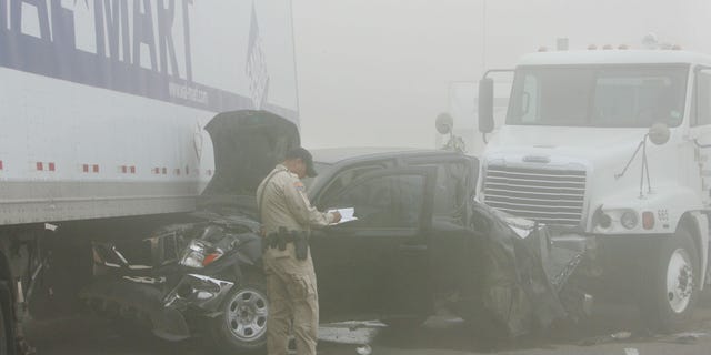 Oct. 4: An Arizona Departmaent of Public Safety Highway Patrol officer investigates the scene of a pileup caused by a dust storm on Interstate 10 west of Casa Grande, Ariz. A blinding dust storm rolled across the Arizona desert Tuesday, causing three pileups involving dozens of vehicles on the major interstate. One man was killed and at least 15 other people were injured, authorities said.