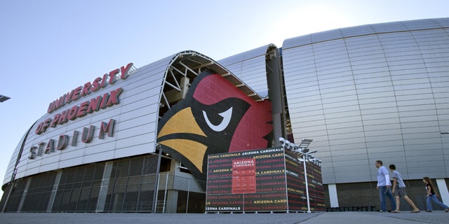 Oct. 11: Pedestrians walk outside of the University of Phoenix Stadium in Glendale, Ariz.