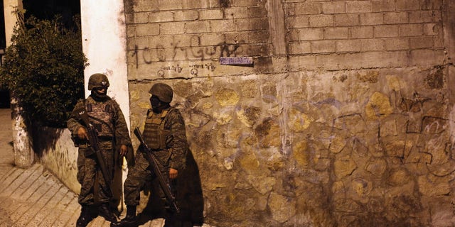 ACAPULCO, MEXICO - MARCH 03: Mexican army soldiers stand guard near a suspected drug-related murder site March 3, 2012 in Acapulco, Mexico. A forensics team excavated five corpses from the floor of an abandoned house. Officials said the five victims were apparently buried alive in concrete. Drug violence has surged in the coastal resort in the last year, making Acapulco the second most deadly city in Mexico after Juarez. One of Mexico's top tourist destinations, Acapulco has suffered a drop in business, especially from foreign tourists, due to the violence. Toursim accounts for about 70 percent of the economy of Acapulco's state of Guerrero and 9 percent of Mexico's economy. (Photo by John Moore/Getty Images)