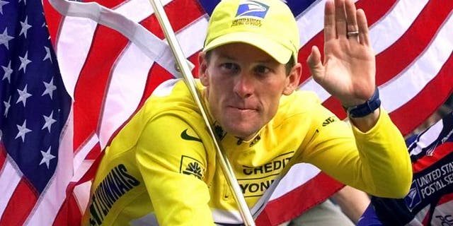 July 23, 2000: Lance Armstrong rides down the Champs Elysees after the final stage of the Tour de France cycling race in Paris.