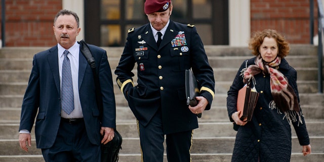 In this March 4, 2014 file photo, Brig. Gen. Jeffrey Sinclair leaves the courthouse with his lawyers Richard Scheff, left, and Ellen C. Brotman, following a day of motions at Fort Bragg, N.C.