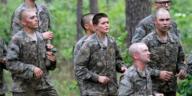 April 19, 2015: One of 20 female soldiers, center, among the 400 students who qualified to start Ranger School runs in place in between obstacles on the Darby Queen, one of the toughest obstacle courses in U.S. Army training, at Fort Benning, Ga. (Robin Trimarchi/Ledger-Enquirer via AP, File)