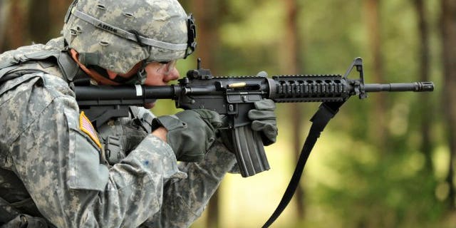Spc. Ethan Esposito, Joint Multinational Training Command, fires his M4 carbine rifle during United States Army Europe's Best Warrior Competition in Grafenwoehr, Germany, July 31, 2012. (U.S. Army)