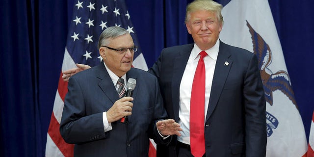 In this Jan. 26, 2016 photo, Donald Trump is joined onstage by then-Maricopa County Sheriff Joe Arpaio at a campaign rally in Marshalltown, Iowa.