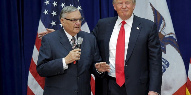 In this Jan. 26, 2016 photo, Donald Trump is joined onstage by then-Maricopa County Sheriff Joe Arpaio at a campaign rally in Marshalltown, Iowa.