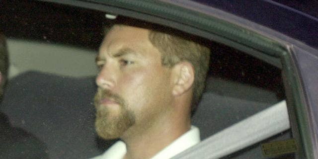 Scott Peterson arrives at county jail after being charged with murdering his wife and unborn child in April 2003.