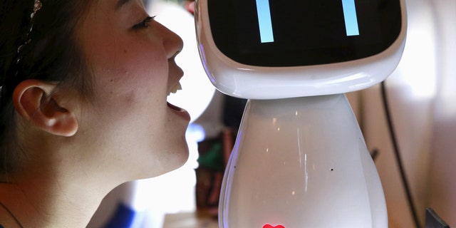 File photo: A visitor speaks to Baidu's robot Xiaodu at the 2015 Baidu World Conference in Beijing, China, September 8, 2015. (REUTERS/Kim Kyung-Hoon)