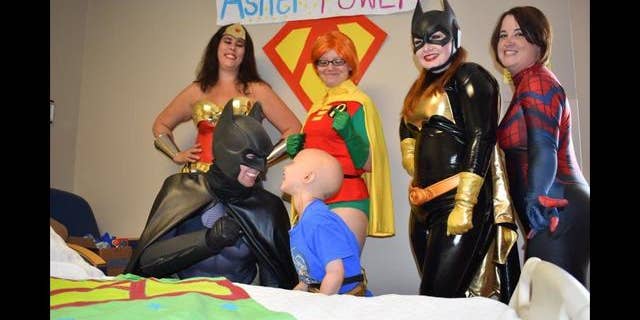 Asher Thrift smiled from ear-to-ear on when Batman, Robin, Batgirl, Wonder Woman, and Spiderman all came into his room.