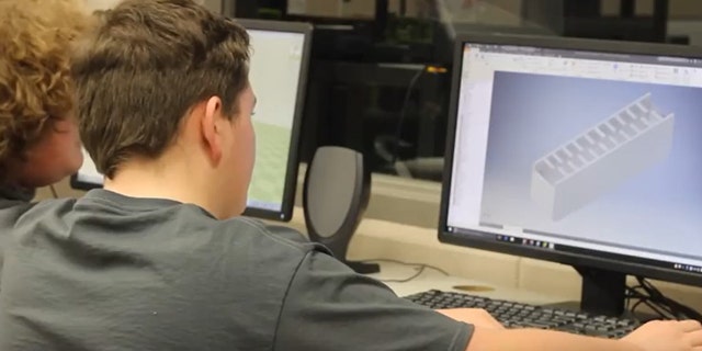Students study a computer-generated image of the device (Screenshot from Samsung YouTube video)
