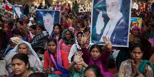 Nov. 18, 2014: Supporters of controversial Indian guru Sant Rampal displaying his photographs, chant slogans praising him as they gather to show support at a protest venue near the Indian Parliament in New Delhi, India. In the neighboring Haryana states Hisar district, several supporters were injured on Tuesday after police searching for Rampal stormed an ashram where he was believed to be holed up.
