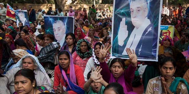 Nov. 18, 2014: Supporters of controversial Indian guru Sant Rampal displaying his photographs, chant slogans praising him as they gather to show support at a protest venue near the Indian Parliament in New Delhi, India. In the neighboring Haryana states Hisar district, several supporters were injured on Tuesday after police searching for Rampal stormed an ashram where he was believed to be holed up.