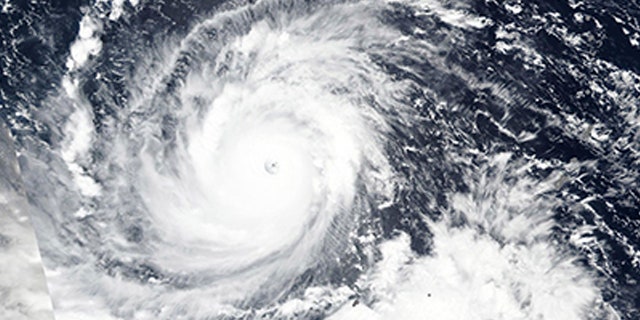n this Wednesday, Sept. 12, 2018, NASA satellite image, Super Typhoon Mangkhut churns west towards the Philippines.
