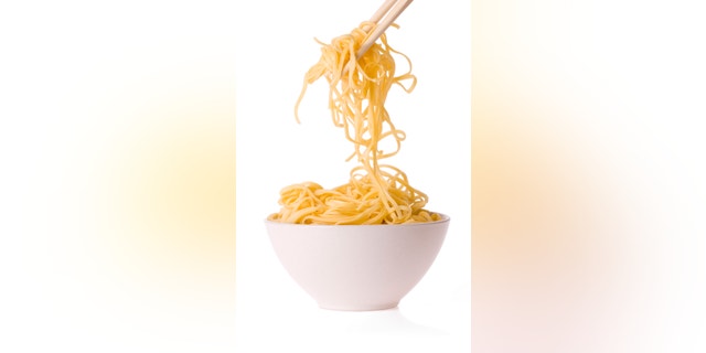 chopsticks,bowl and noodles on white background
