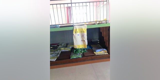 Pic shows: The sleeping platforms in the classroom and the hanging quilt
A young boy has died in a freak nap time accident at his nursery school after ropes on a blanket became tangled around his neck.
The four-year-old surnamed Lin was one of several young pupils who were resting in the Shuangqiao Mingzhu Kindergarten classroom after lunch and is believed to have suffocated by himself.
According to the childâs teacher, the boy was found without breath sounds at 2pm when nap time ended, and he was confirmed dead after being rushed to hospital in Xiamen City, in East Chinaâs Fujian Province.
The nursery school said thin ropes attached to the classroomâs quilts - specially designed to be rolled up and easily carried - had somehow become wrapped around the childâs neck when dangling from above.
The school said the boy, who was sleeping on the lower of two platforms, most likely lost consciousness and later died of asphyxiation shortly after.
Investigators have already ruled out murder and manslaughter from the tragic case, but are now looking into the matter and could charge the teacher and the school principal with negligence.
The teacher claimed to have been too distracted by all the other pupils in class and did not pay special attention to the young victim, whose post-mortem photographs show clear signs of bruising around his neck.
It is unclear whether the nursery school has offered to compensate the Lin family for their tragic loss.
(ends)