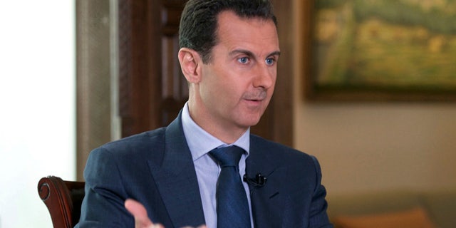 In this Wednesday, Sept. 21, 2016 photo released by the Syrian Presidency, Syrian President Bashar Assad speaks to The Associated Press at the presidential palace in Damascus, Syria.