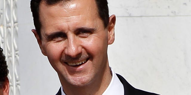 Oct. 21, 2010 : FILE - In this file photo, Syrian President Bashar Assad smiles as he shakes hands with Venesuela's President Hugo Chavez, not seen, at the Syrian presidential palace, in Damascus, Syria.